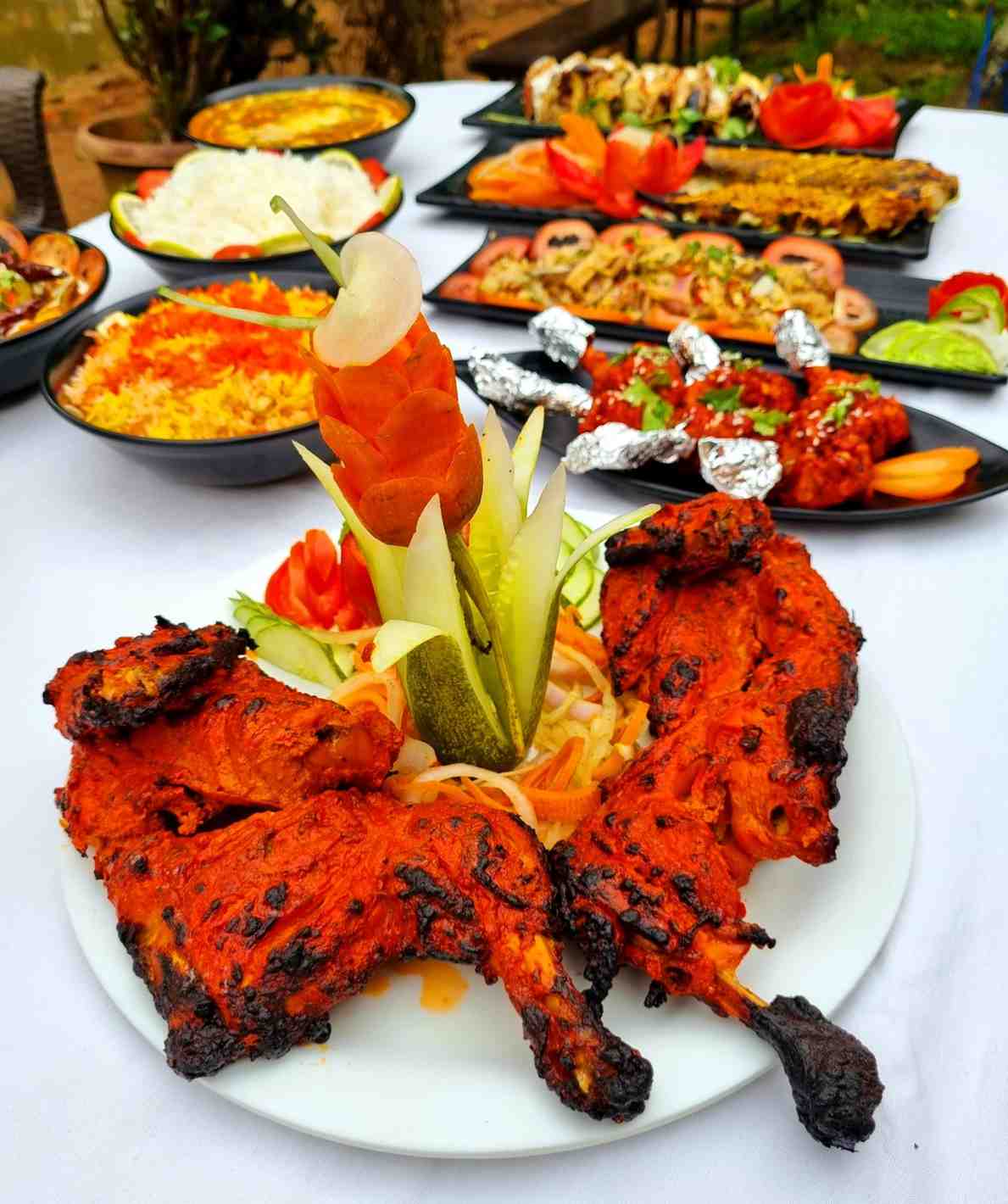 A spread of grilled platters and Assamese dishes