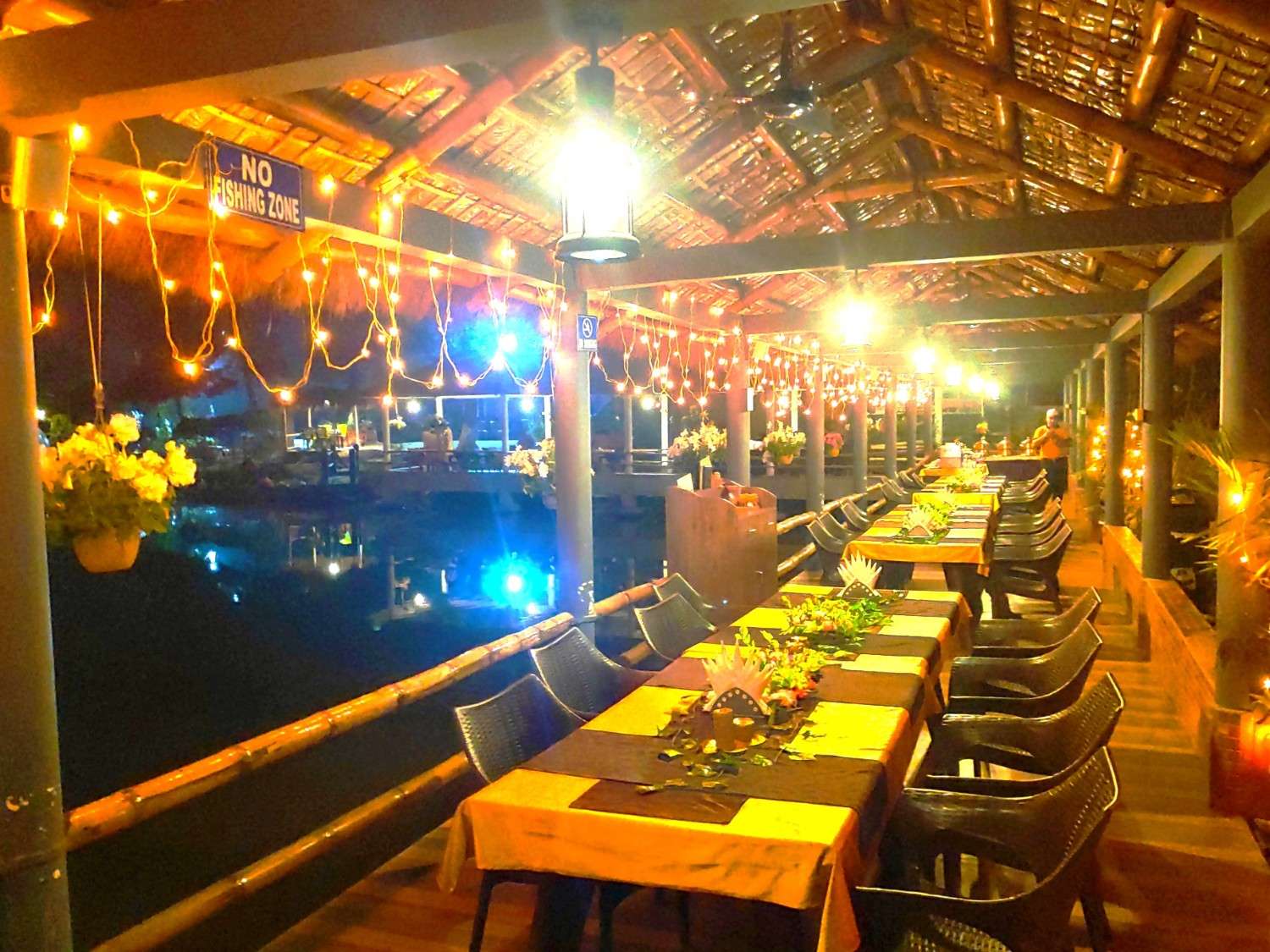 The pondside dining walkway lit up at night